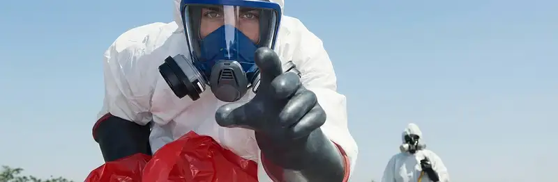 sewage clean up technician wearing protective gear handling biohazard materials in Charleston, SC