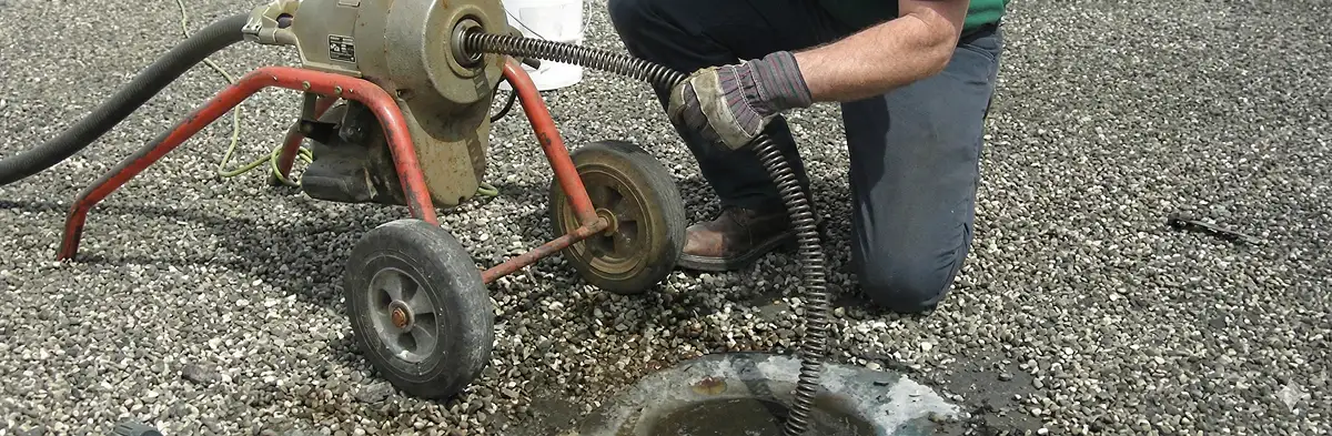 sewer rodding technician actively removing blockages from a sewer line in Charleston, SC